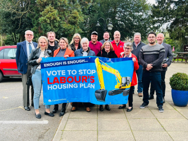 Conservative candidates for the Bassetlaw District Council 2023 local elections holding a banner opposing Labour's housing plan